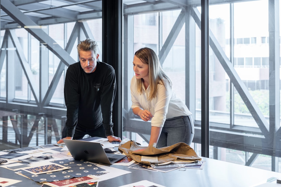 man and woman sitting at table, Sales meeting in an open-plan office