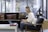 A professional lawyer working on a laptop in a modern office environment.