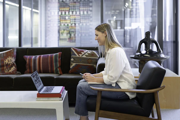A professional employee using an integrated service portal on a laptop in a modern office.