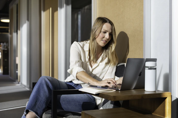 Realtor planning the week at a bright desk with a laptop
