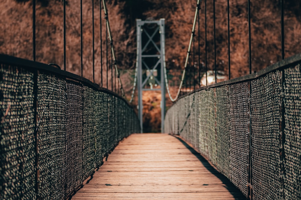 brown wooden bridge with black metal fence