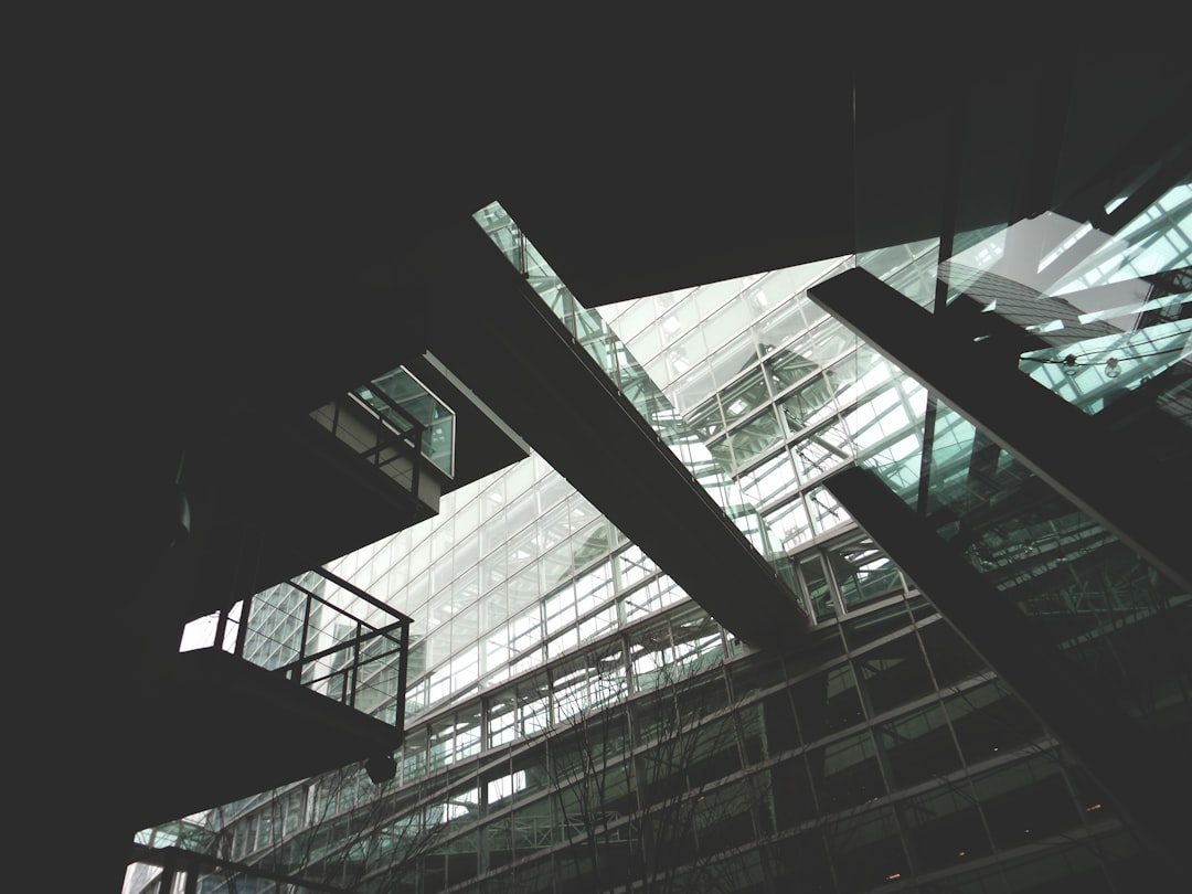 grayscale photo of glass walled building