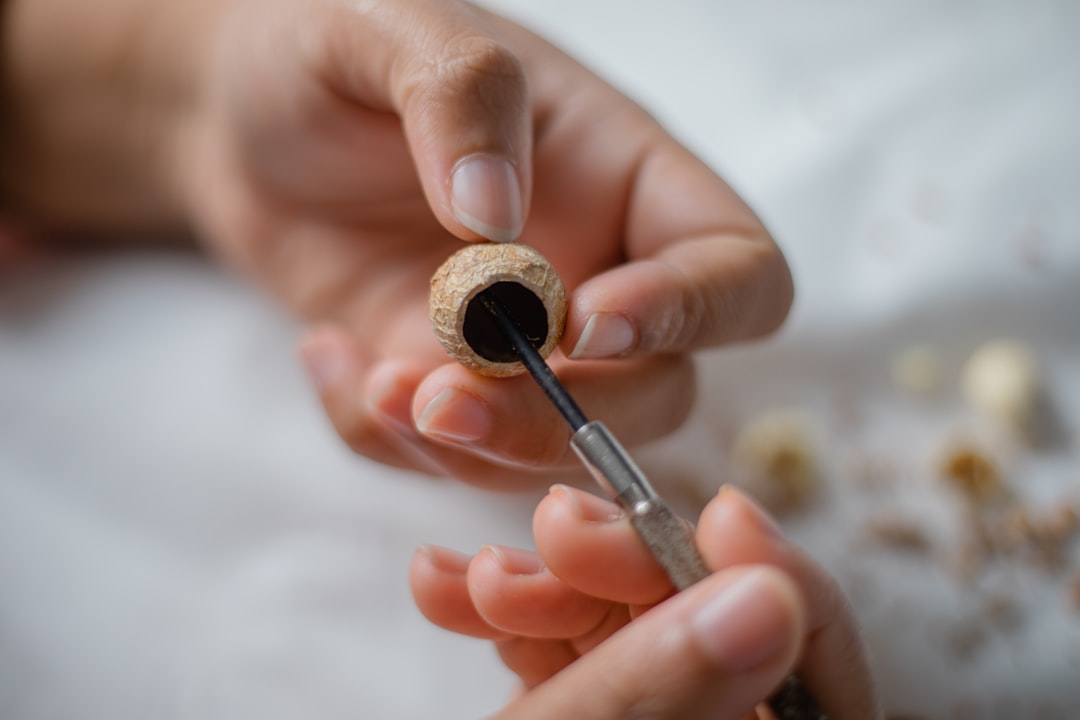 person holding black and silver pen