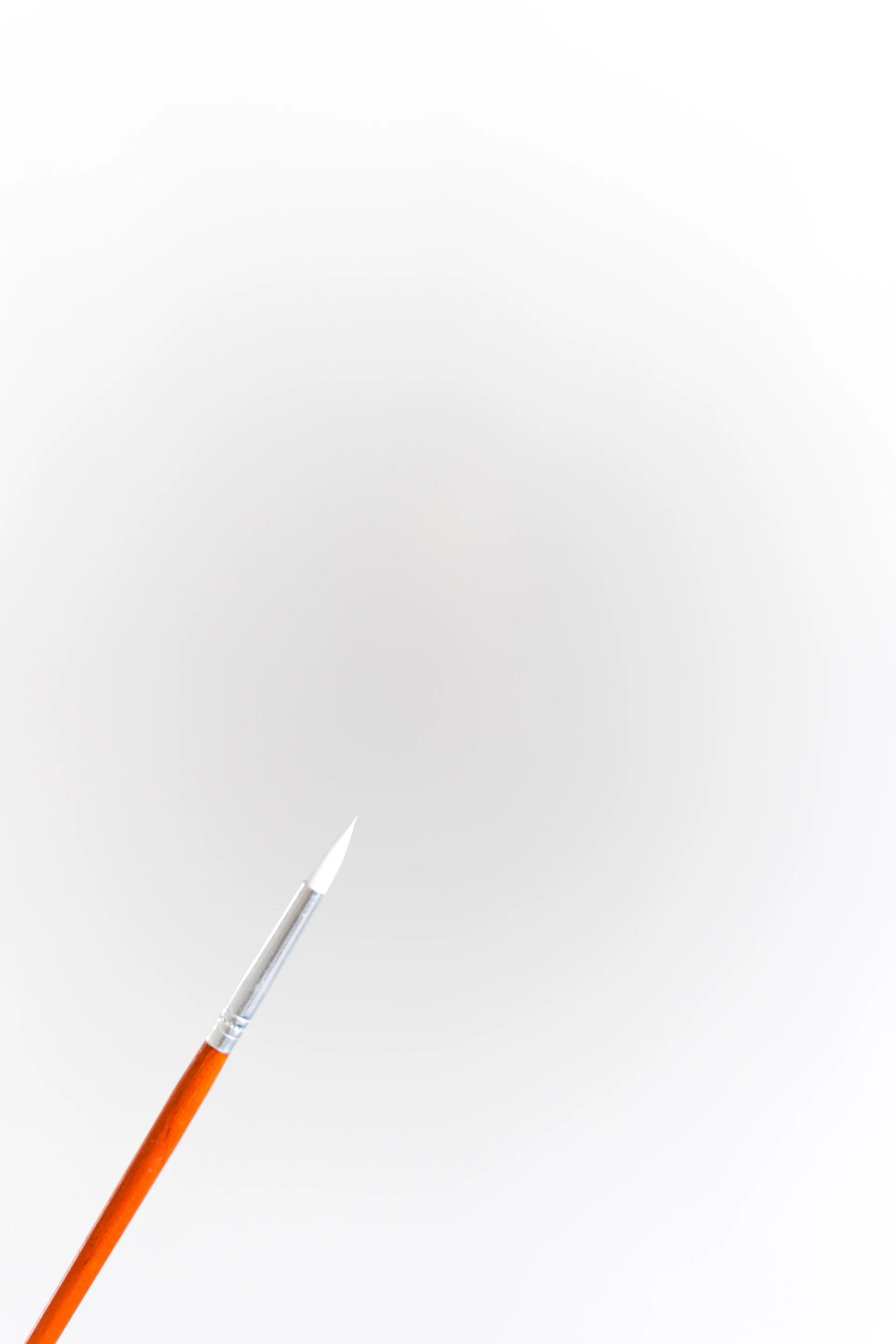 orange and white pen on white surface
