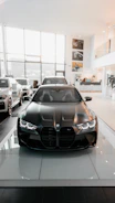 A sleek new car displayed in a modern showroom with bright lighting