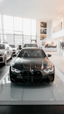 A sleek new car displayed in a modern showroom with bright lighting