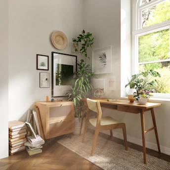 A wooden desk and chair in a sunlit home office corner with plants