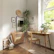 A serene studio corner with sunlight filtering through windows onto art tools and plants.