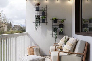 2 brown wooden armchairs beside white wall