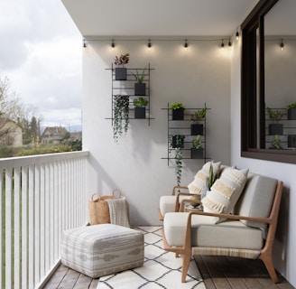 2 brown wooden armchairs beside white wall