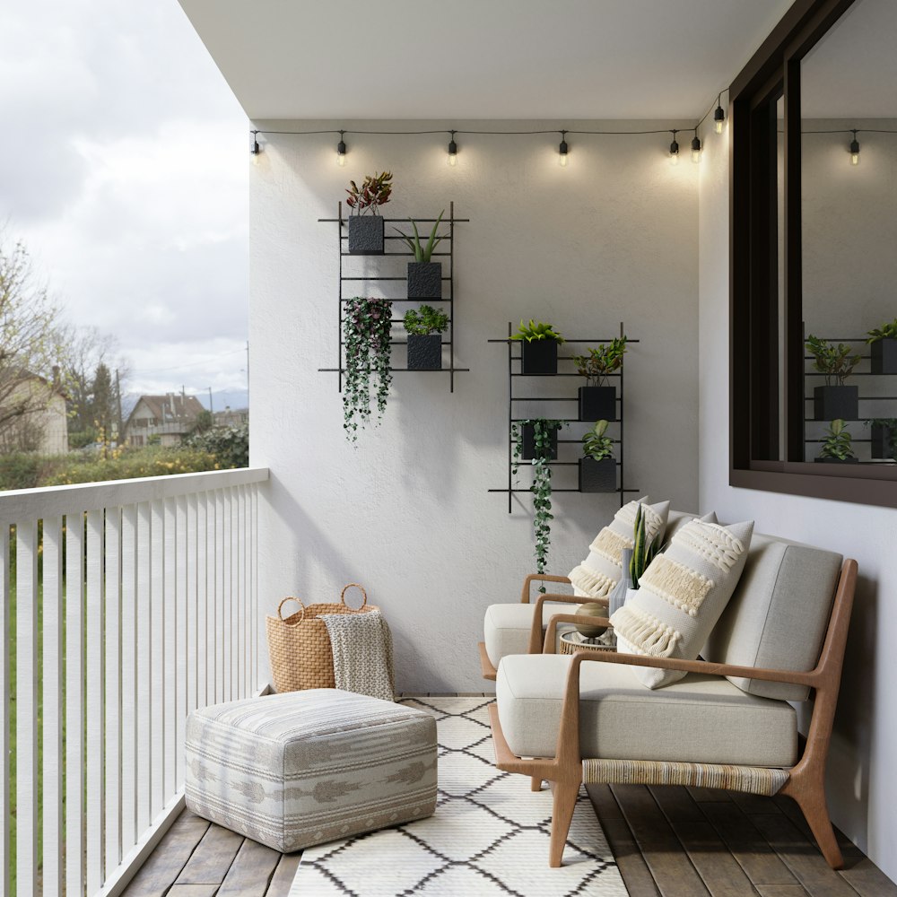 2 brown wooden armchairs beside white wall