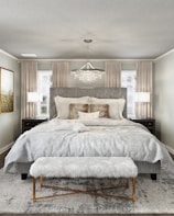 A cozy bedroom showcasing luxurious bedding and decor.
