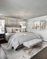 A modern bedroom featuring a gray chenille rug beside the bed.