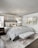 Modern bedroom with a stylish bed featuring a custom base and soft bedding