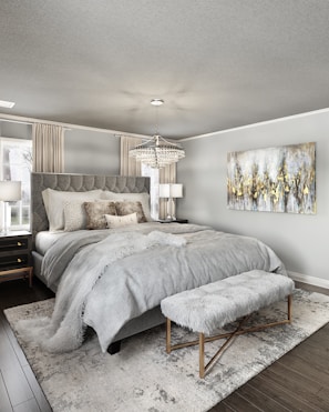 A modern bedroom featuring a gray chenille rug beside the bed.
