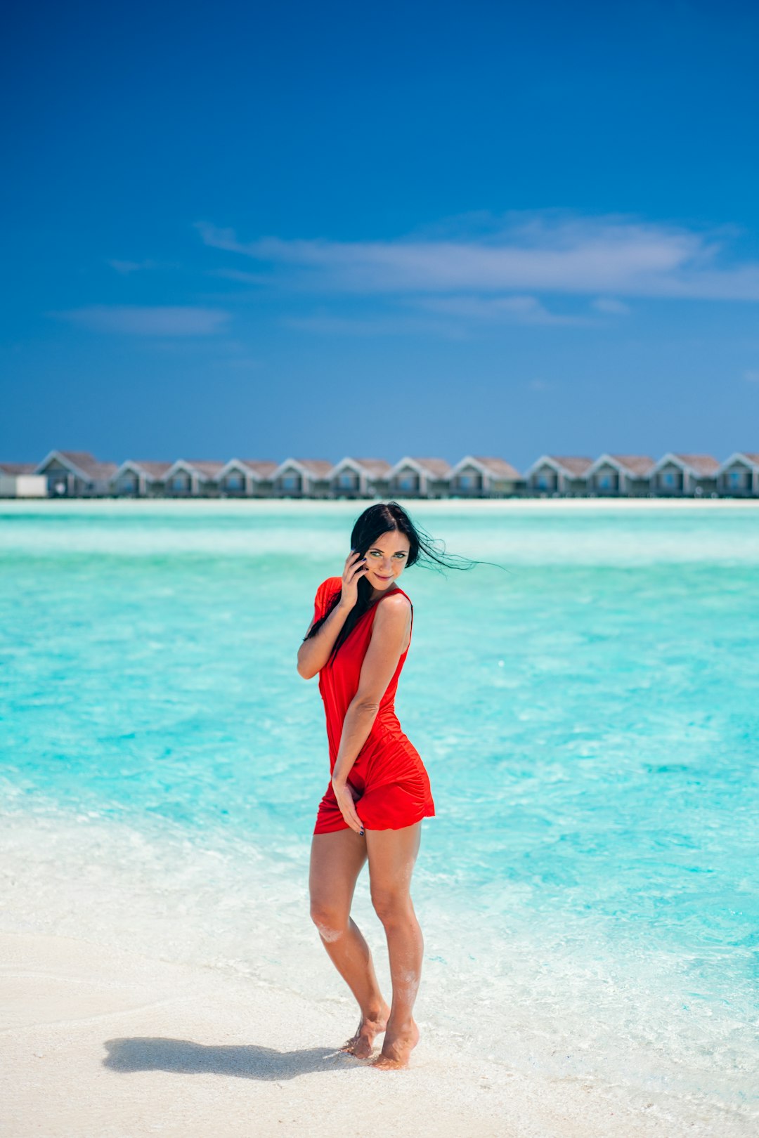 woman in red swimsuit standing on beach during daytime