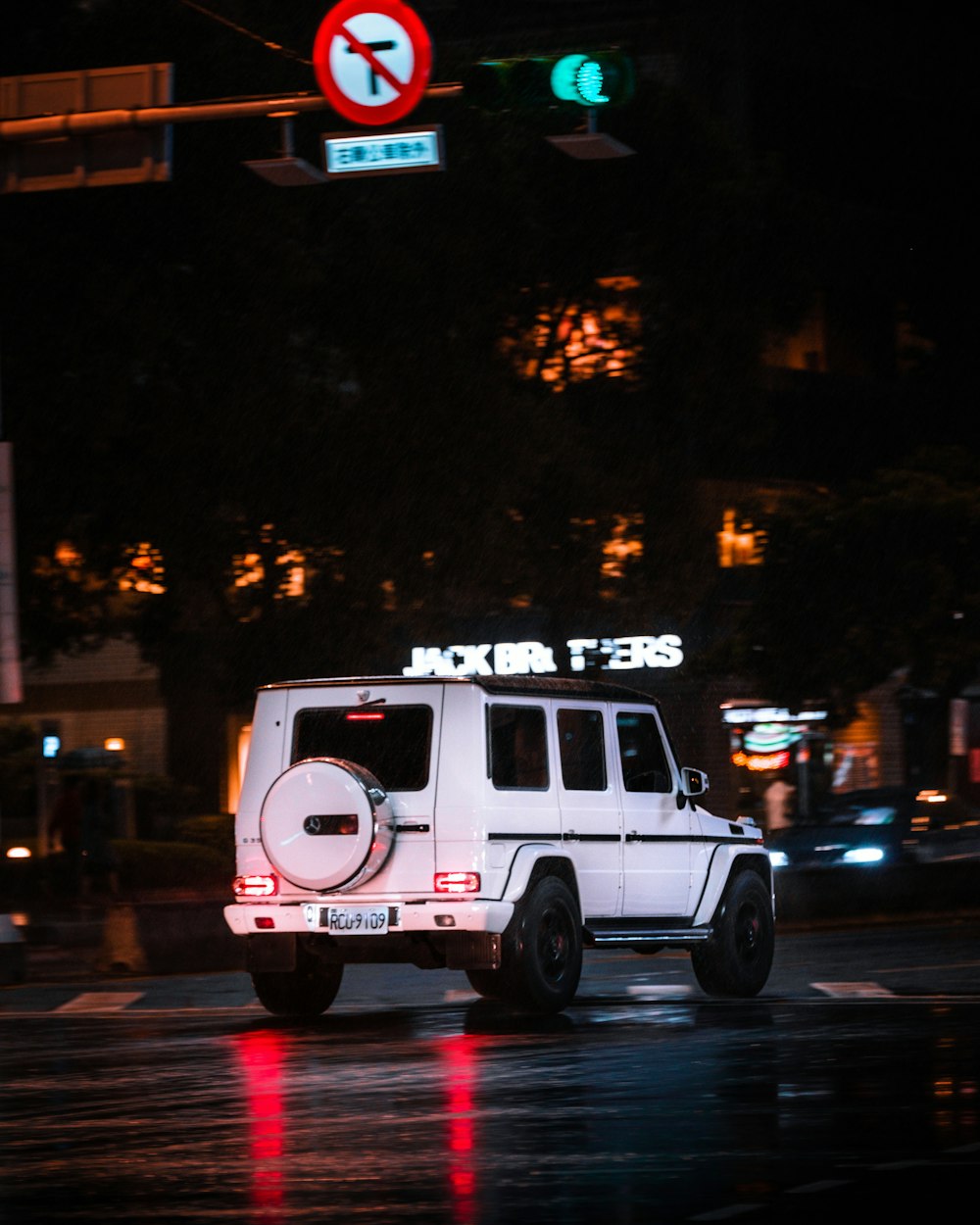 white and pink van on road during night time