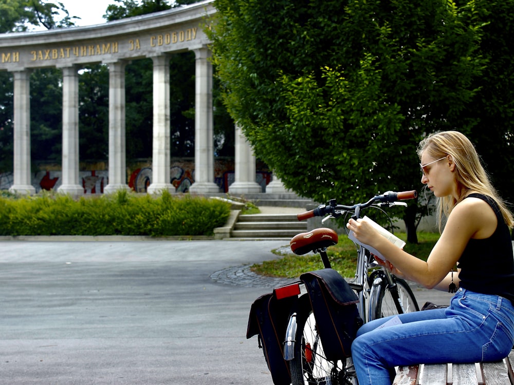 woman in blue denim shorts riding on red motorcycle during daytime