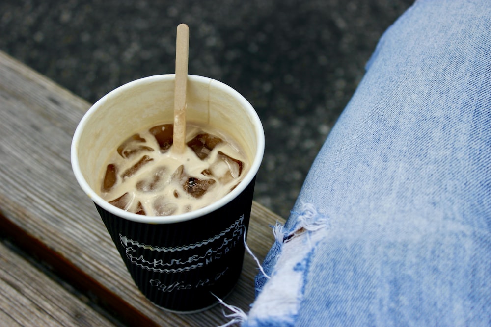 black and white disposable cup with white plastic spoon