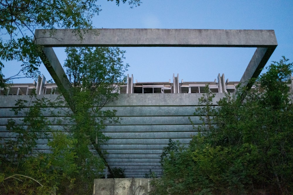 green trees near white and gray concrete building during daytime