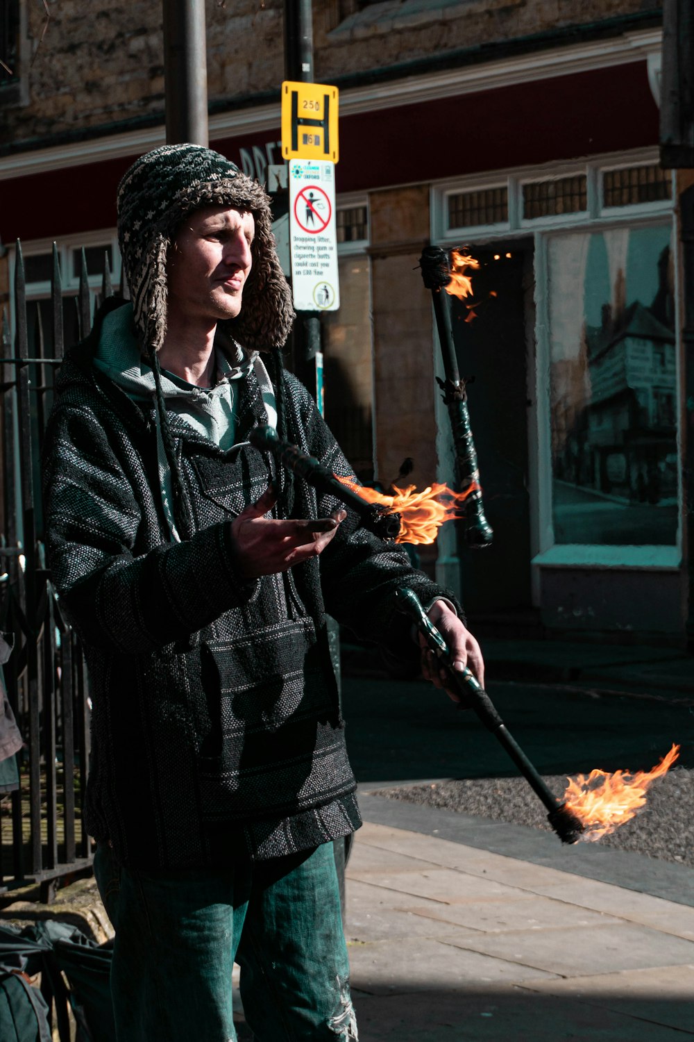 man in black and white plaid coat holding fire