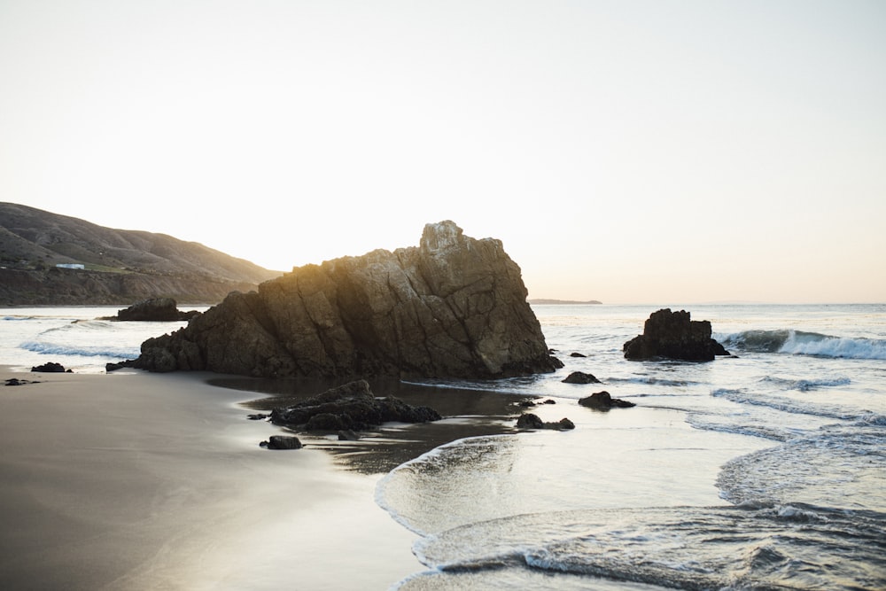 brown rock formation on sea during daytime