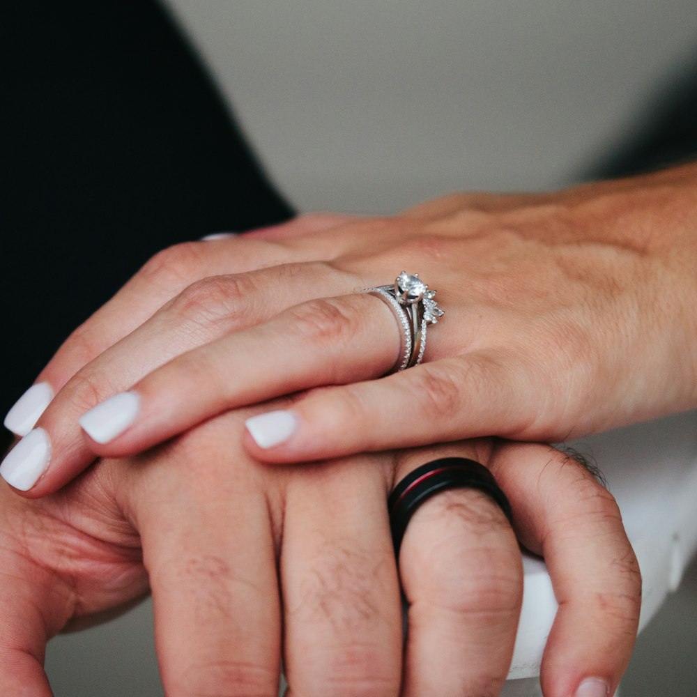 person wearing silver diamond ring