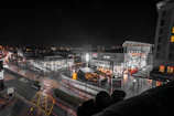 Wide shot of a shopping center parking area illuminated by Robeck Electrical Maintenance’s lighting solutions.