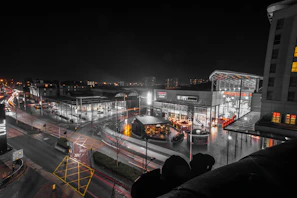 Wide shot of a shopping center parking area illuminated by Robeck Electrical Maintenance’s lighting solutions.