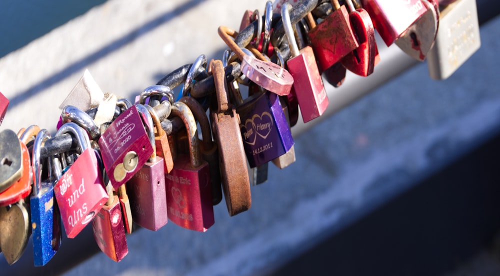 red and blue padlock on black metal fence