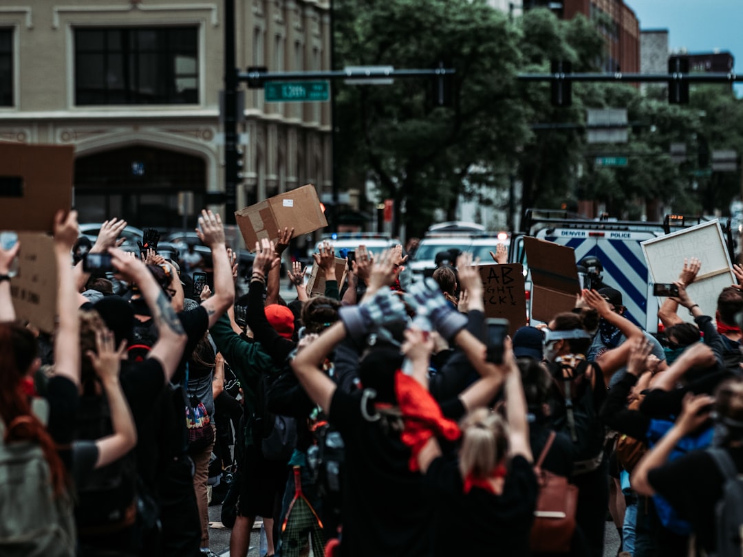 people standing on road during daytime