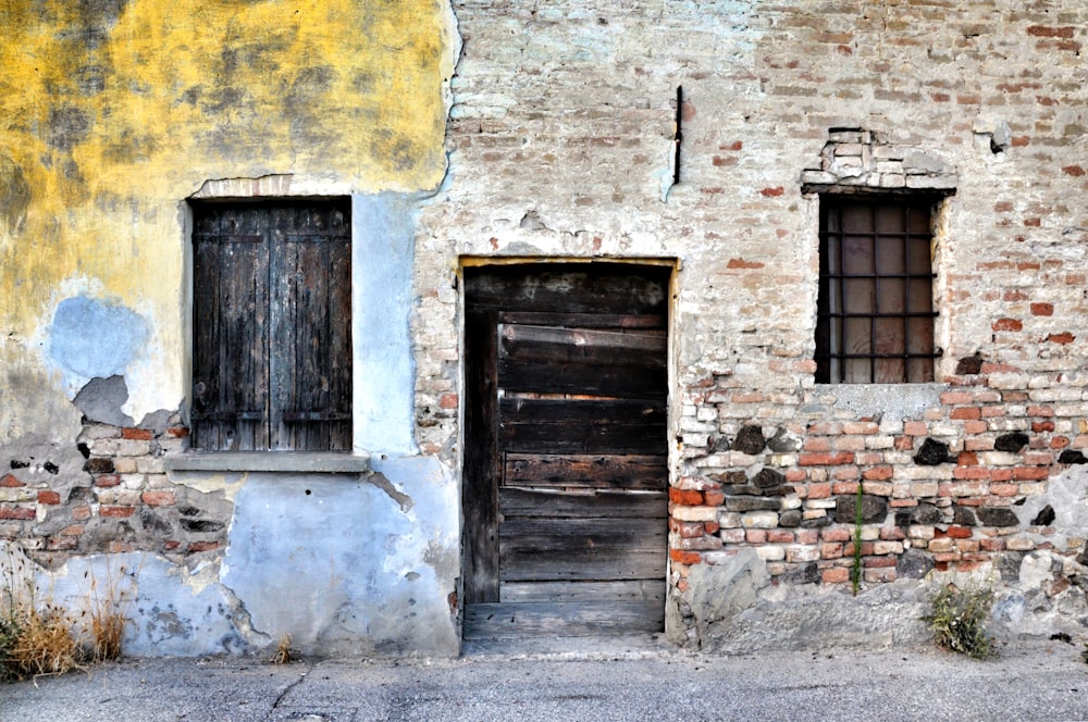 brown wooden door on brown brick wall