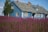purple flower field beside white wooden house during daytime