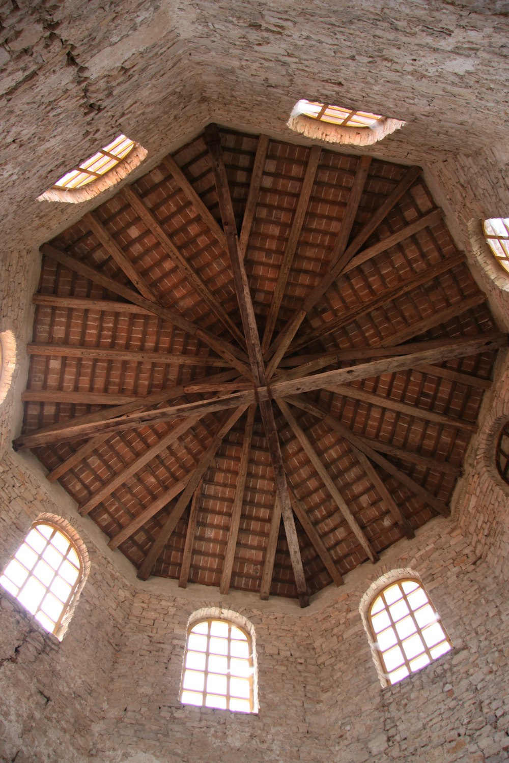 brown wooden ceiling with white round ceiling