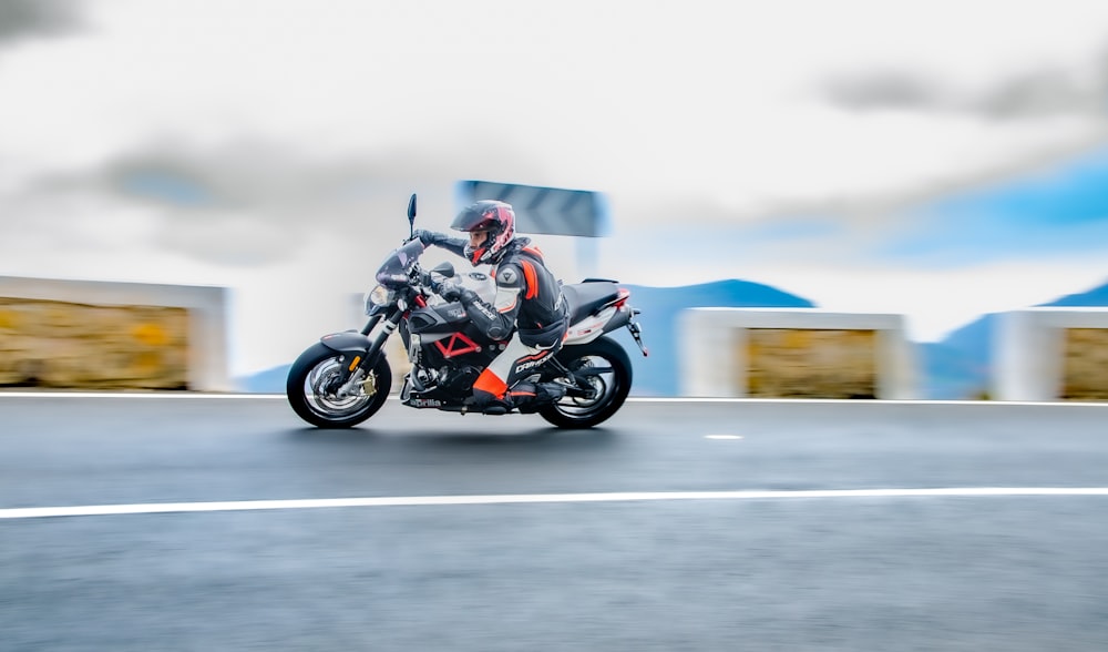 man riding motorcycle on road during daytime