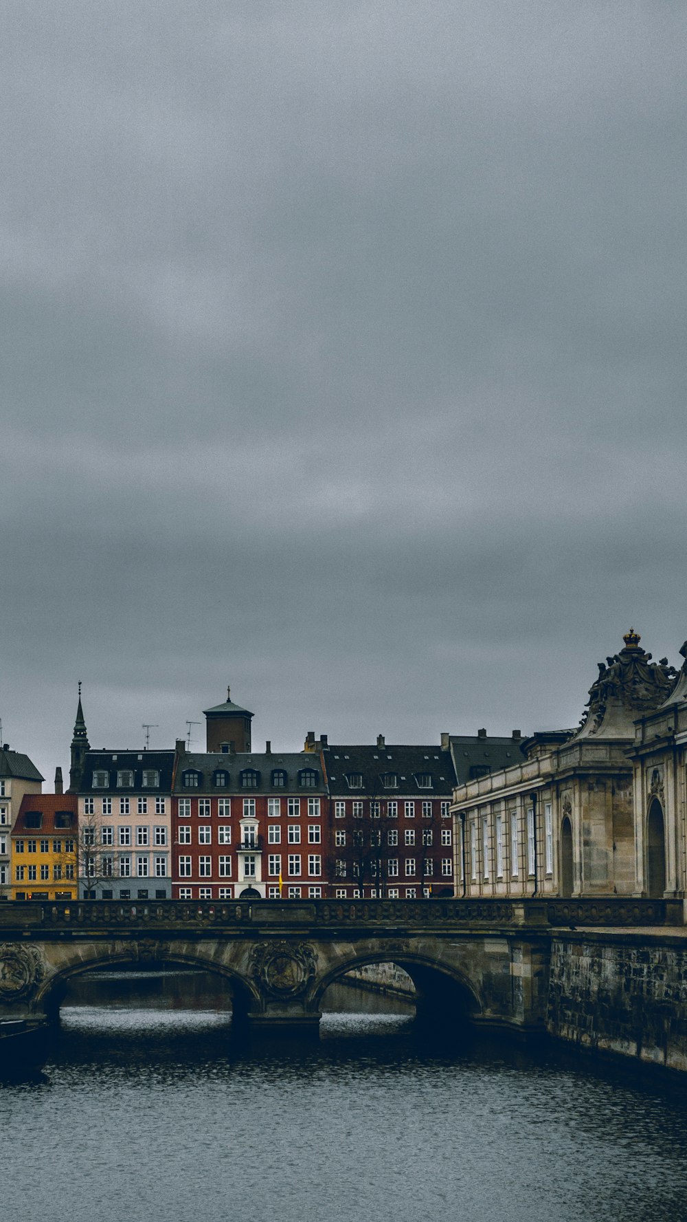 white and black concrete building under gray sky