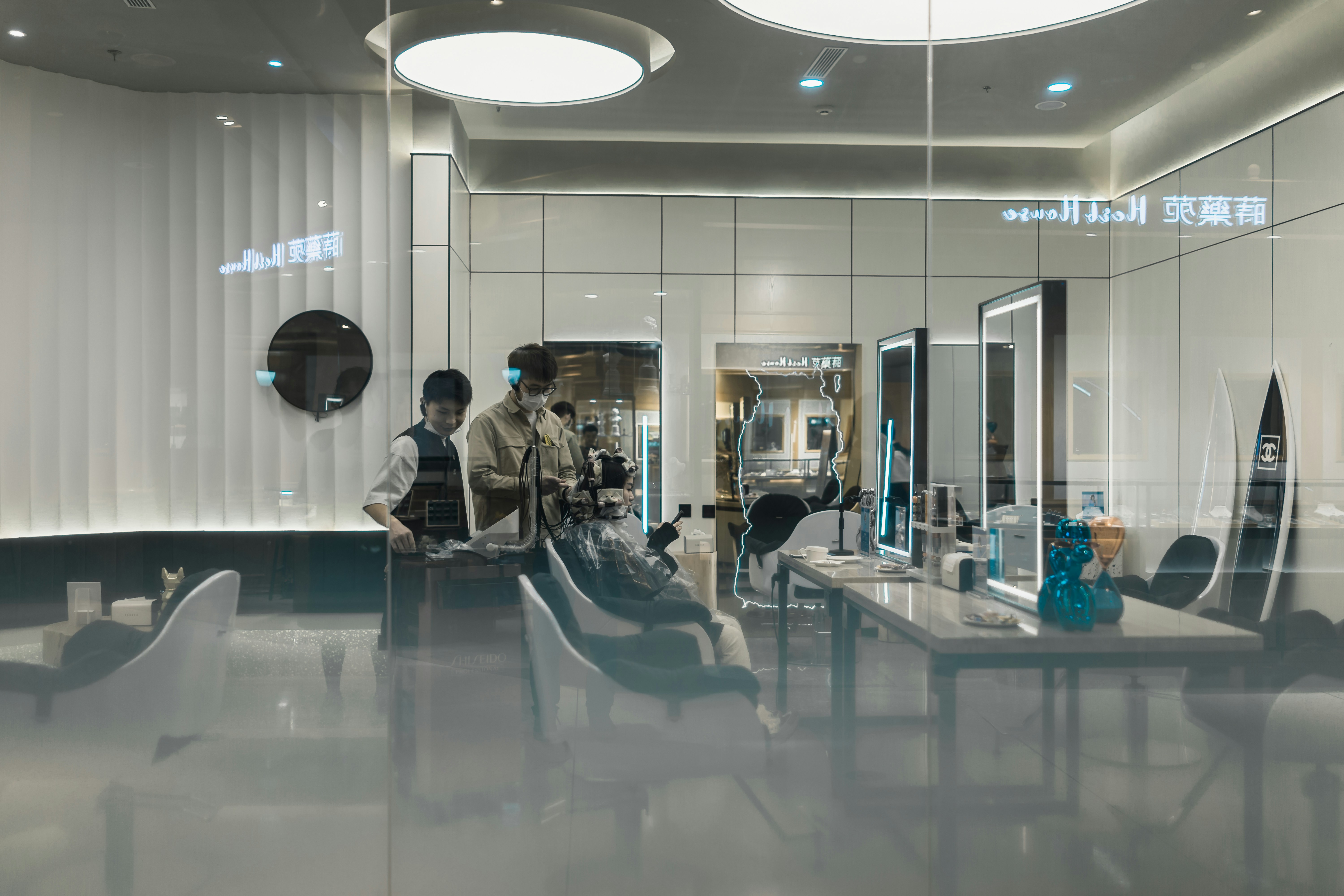 Neelam Salon stylist working on a client's hair in a bright, modern salon environment