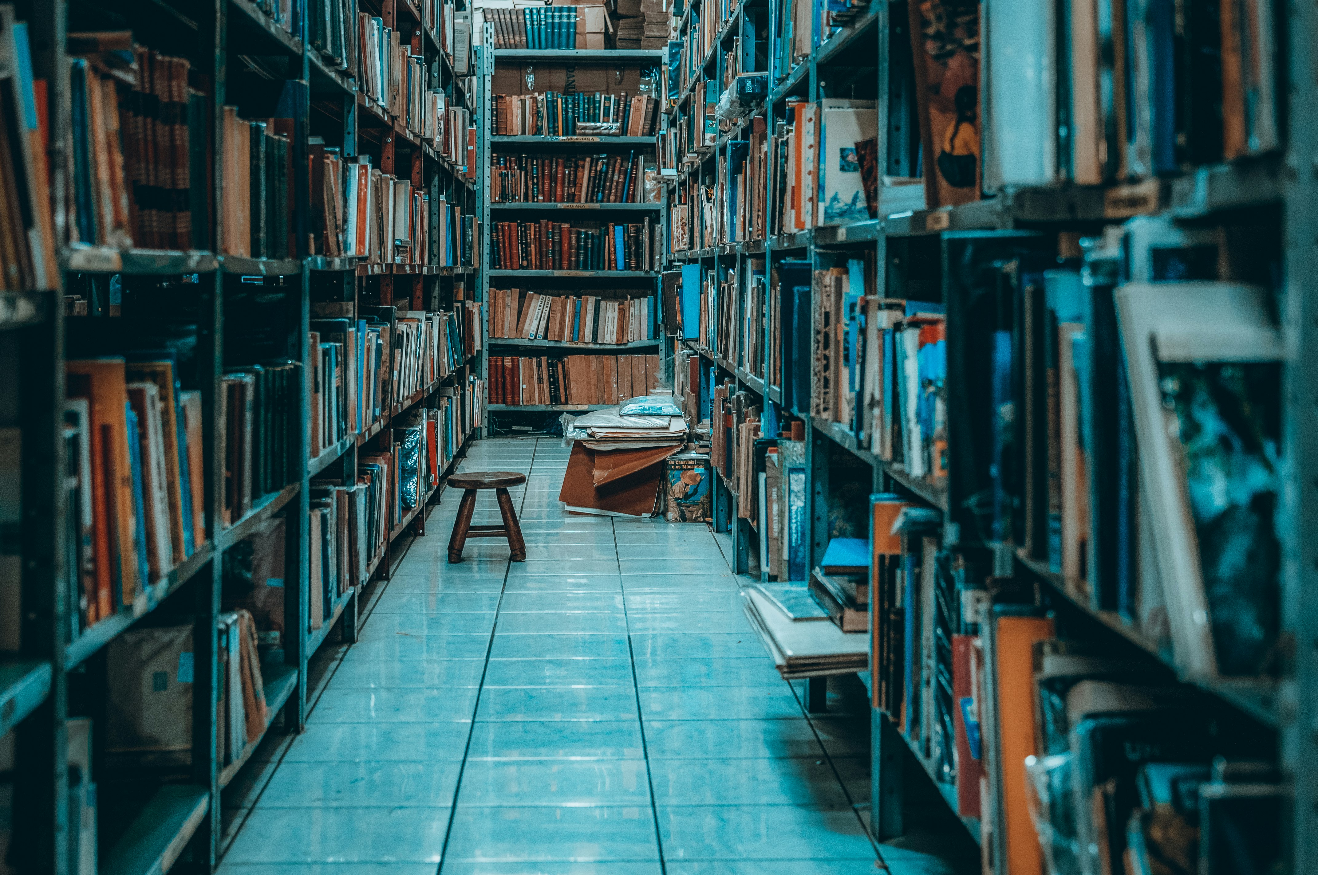 brown wooden table near brown wooden book shelf