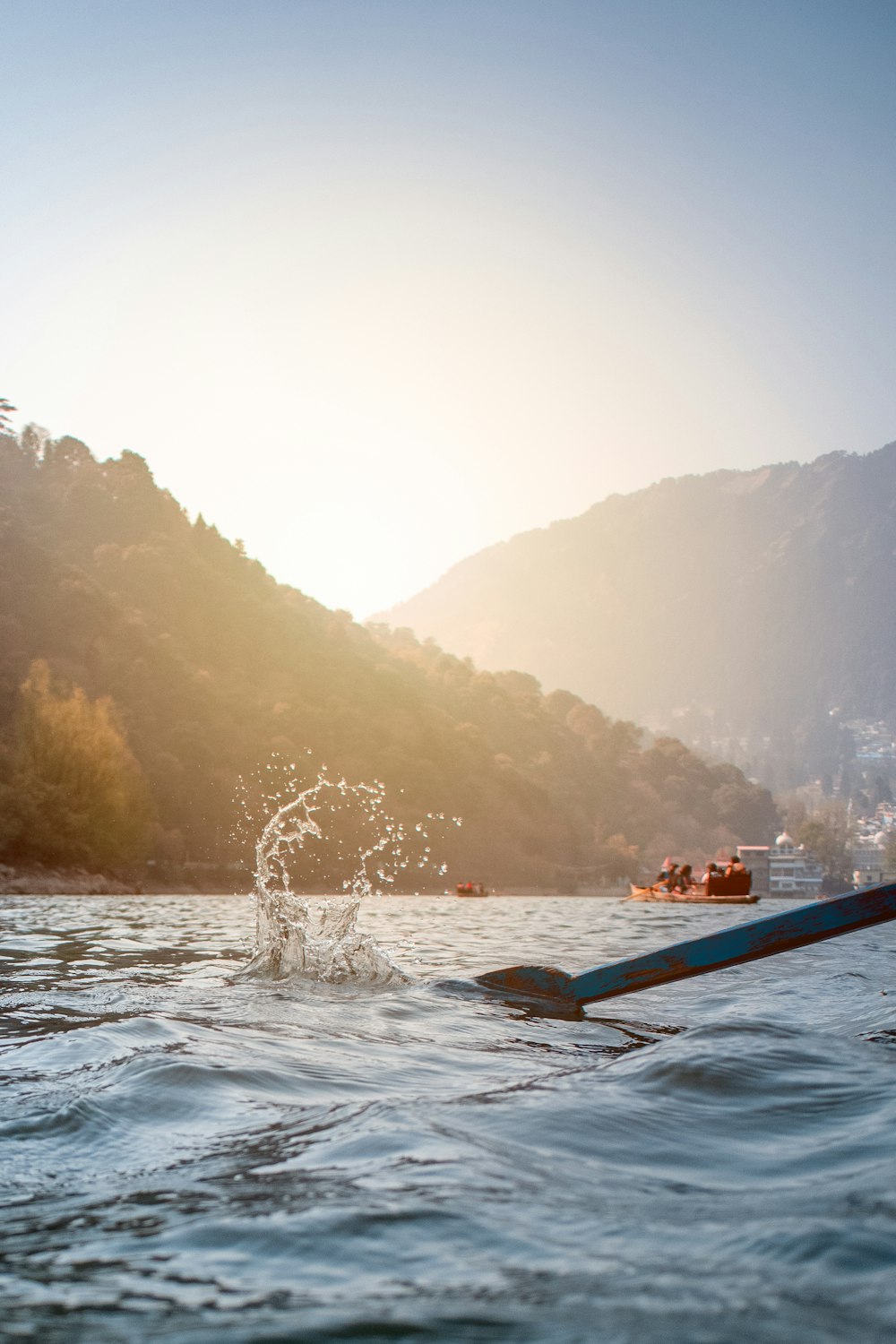 person riding on blue kayak on body of water during daytime