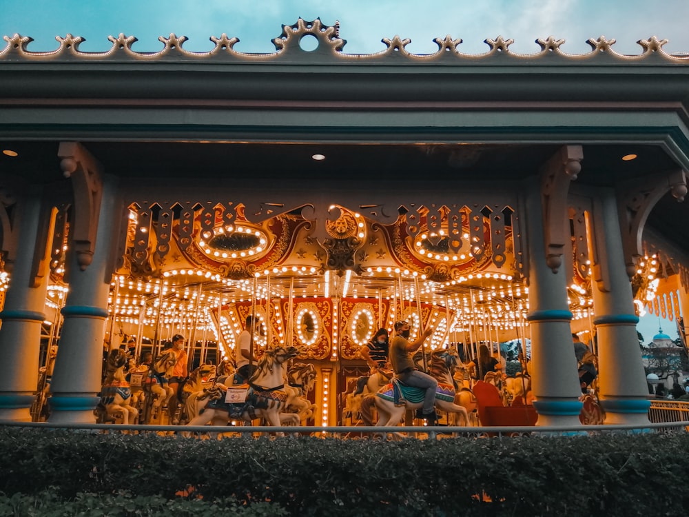 people in gold and blue horse carousel