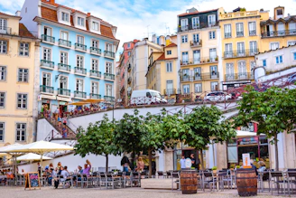 people walking on street near Lisbon buildings during daytime