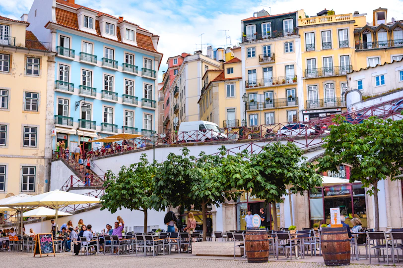 people walking on street near Lisbon buildings during daytime