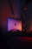 Happy customer unboxing a laptop with a bright Volt Edge logo in the background.