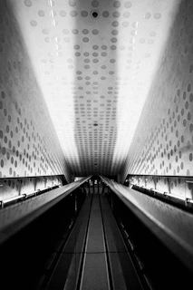 grayscale photo of a escalator