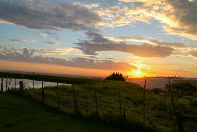 A scenic view of a sunset over a peaceful landscape.