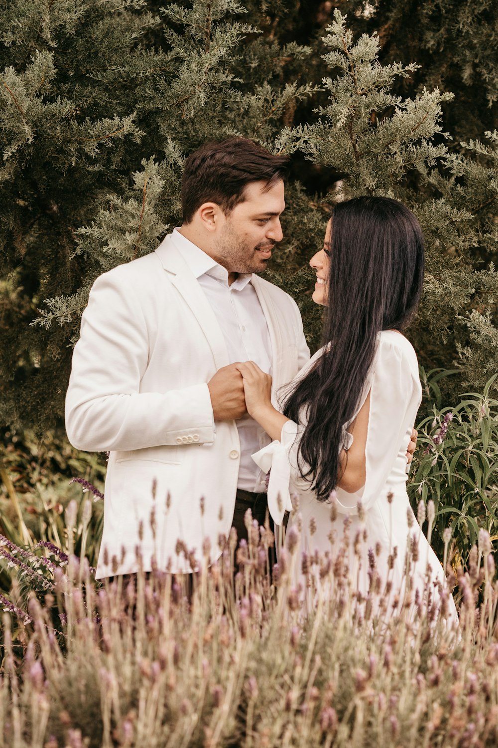 man in white dress shirt kissing woman in white and black dress