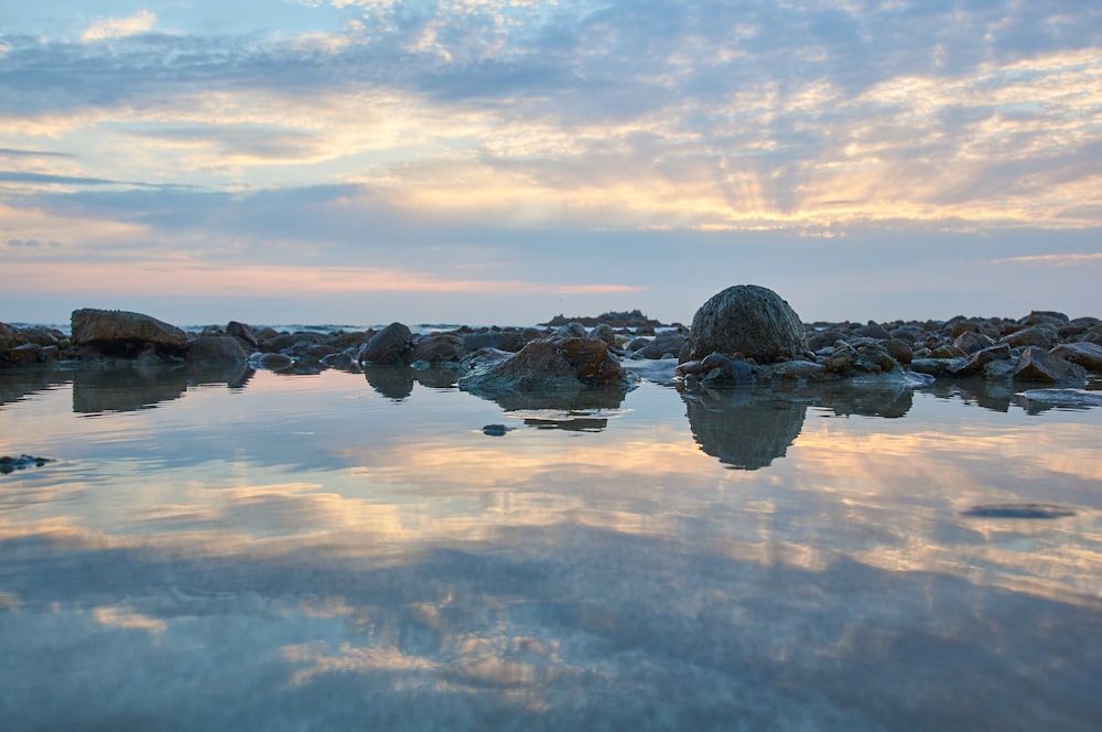 body of water under cloudy sky during daytime