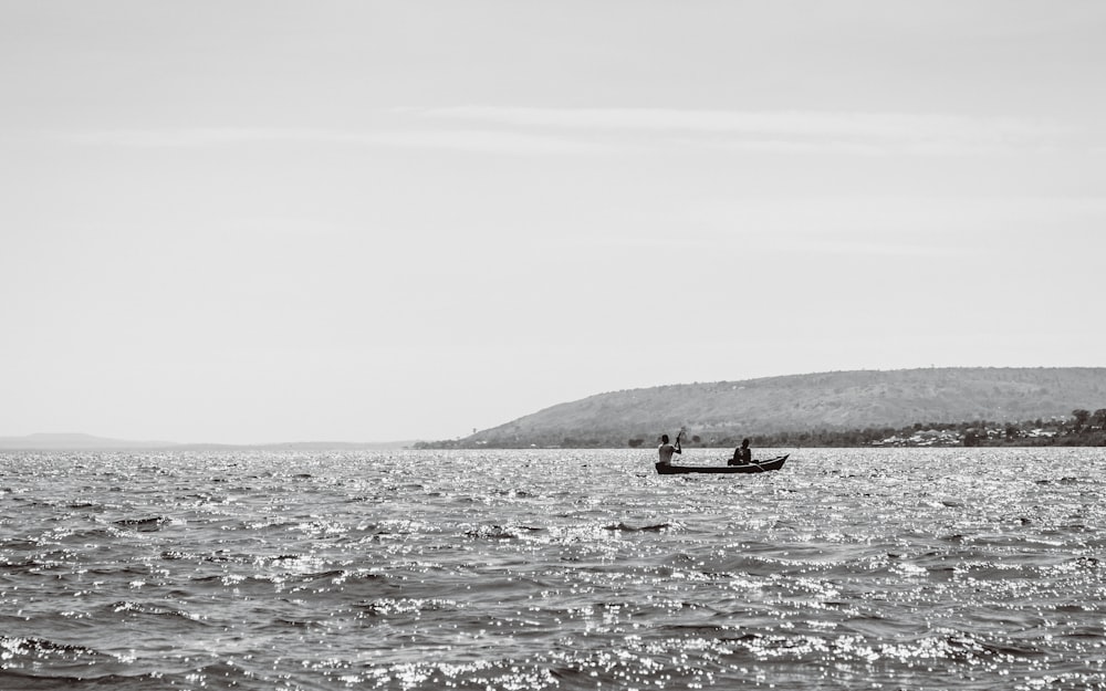 person riding on boat on sea during daytime