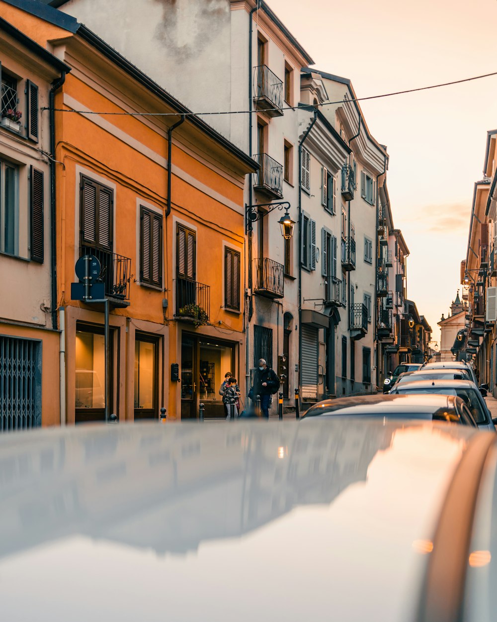 cars parked beside brown concrete building during daytime