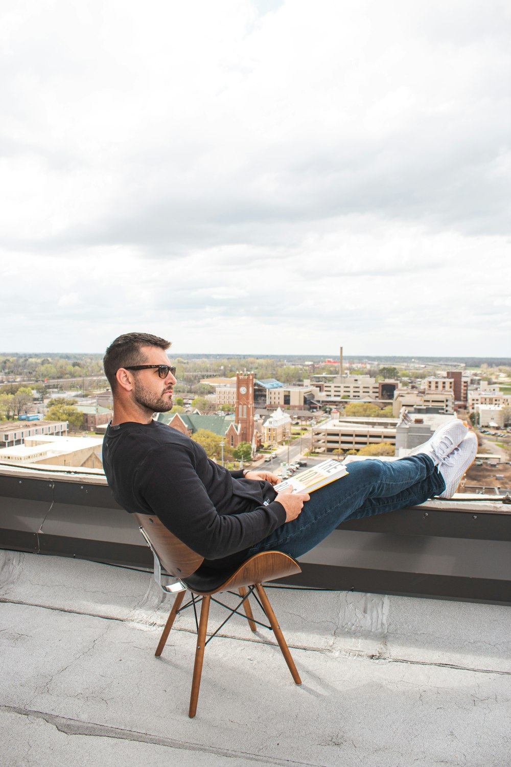 man in black long sleeve shirt sitting on chair during daytime